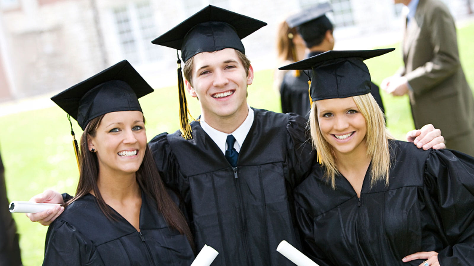 Recent graduates taking a graduation photo