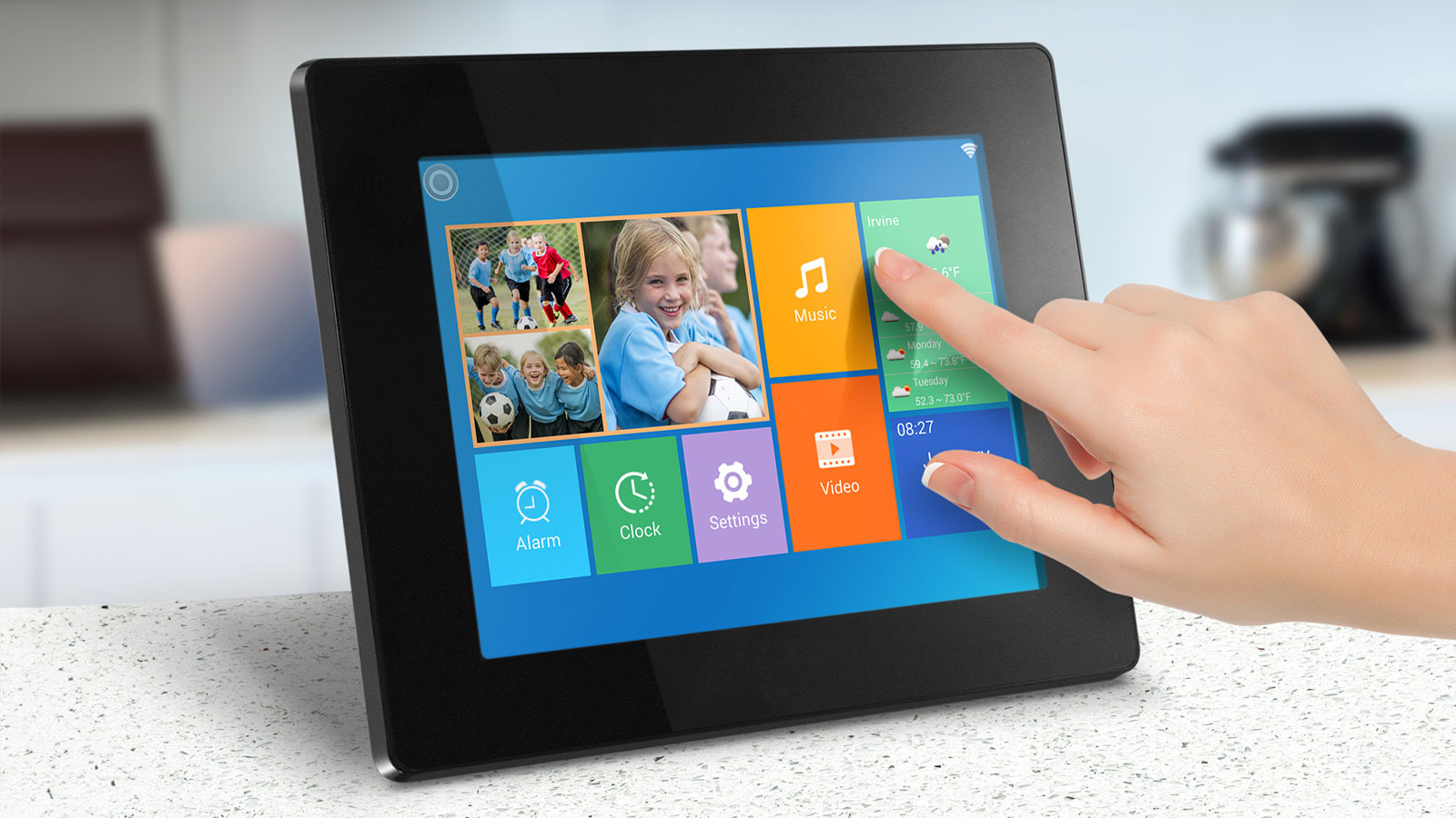 Aluratek digital photo frame on a counter top with a hand controlling the screen