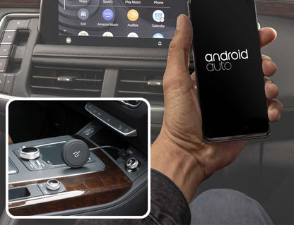 Person holding phone with Wireless Adapter for Android Auto™ on dashboard
