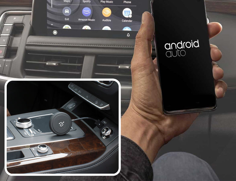 Person holding phone with Wireless Adapter for Android Auto™ on dashboard