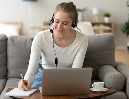 Woman Using the Wired USB Stereo Headset with Noise Reducing Boom Mic and In-Line Controls
