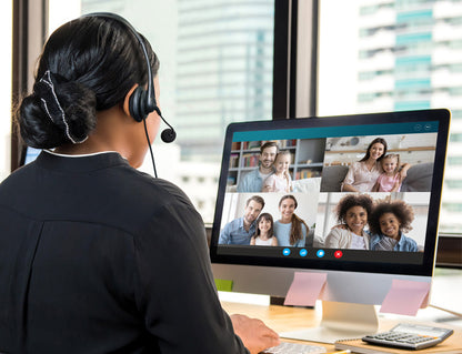 Woman having a call using the Wired USB Stereo Headset with Noise Reducing Boom Mic and In-Line Controls
