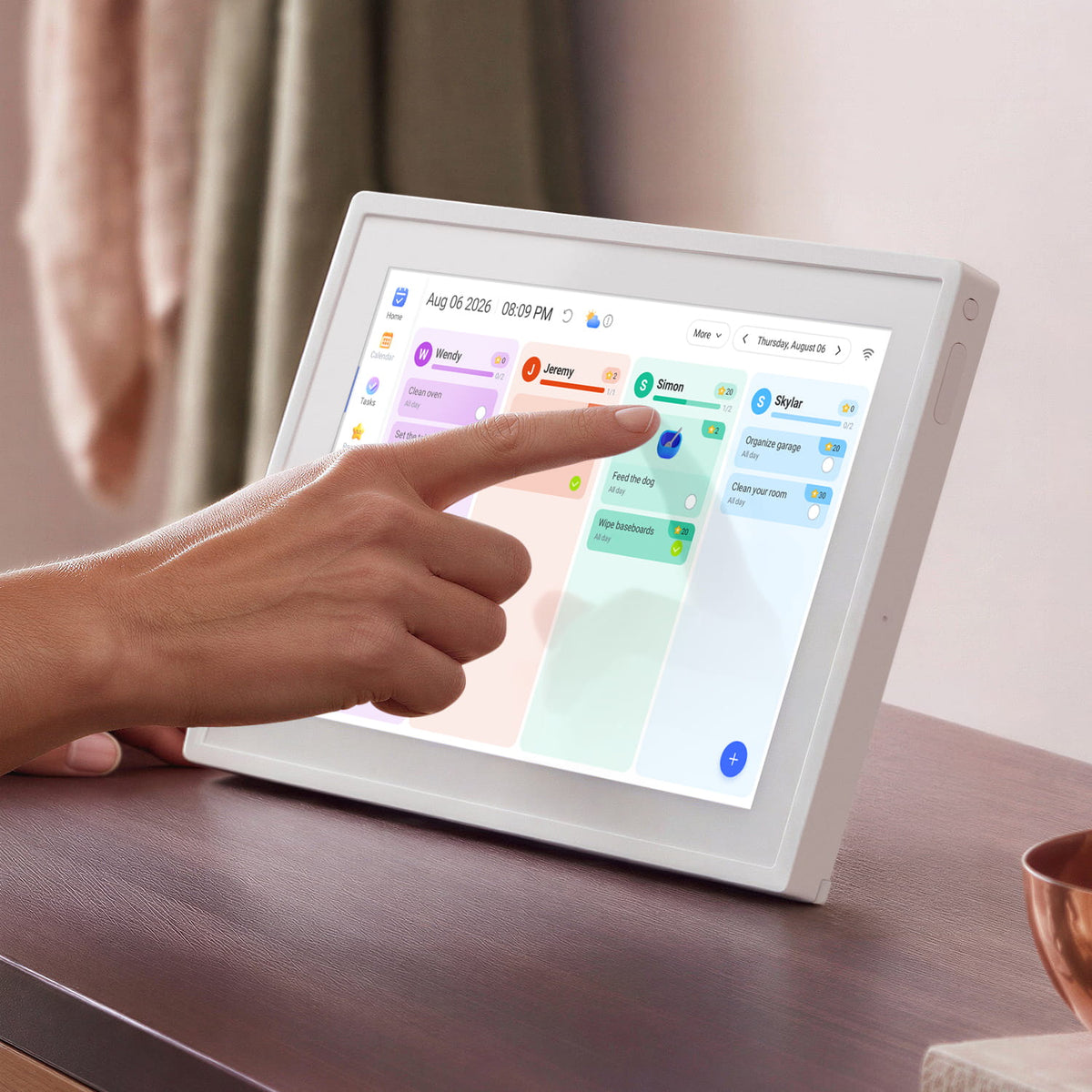 Aluratek 10 inch smart wifi touchscreen digital calendar photo frame with hand on  table